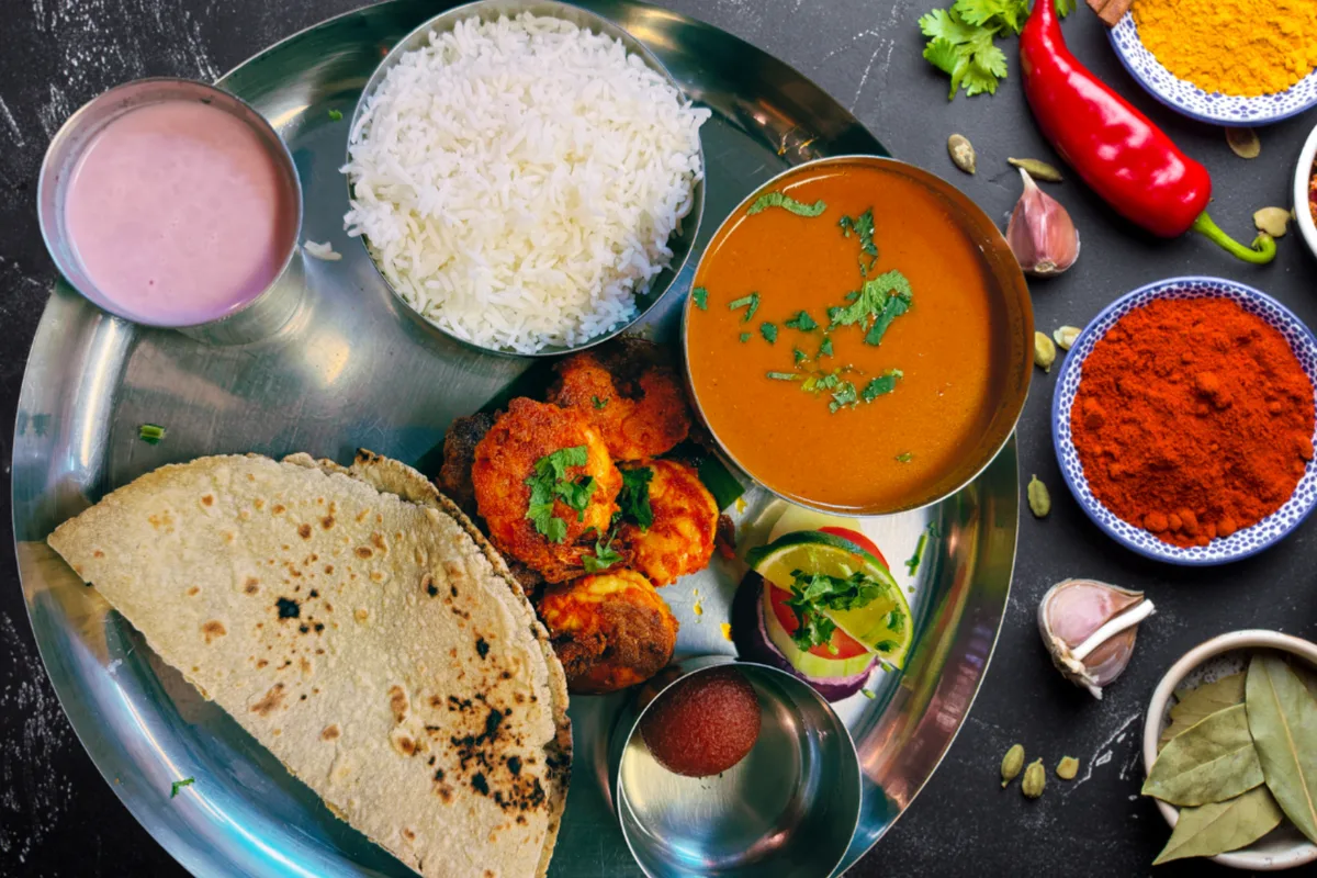 Traditional Maharashtrian thali with curry, rice, chapati and spices - guide to authentic Maharashtrian food