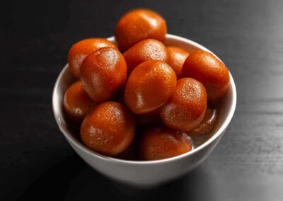 Gulab Jamun - Gulab Jamun is a popular Indian sweet made from milk solids and flour, deep-fried until golden brown, and soaked in a fragrant sugar syrup, resulting in soft and syrupy round balls that are enjoyed as a sweet treat.