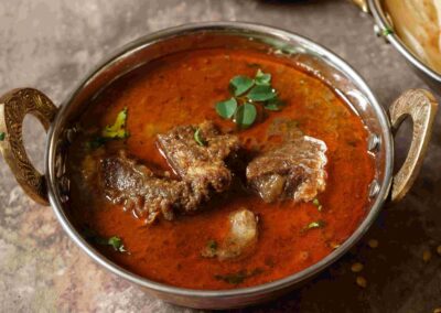 Saoji Mutton - Saoji mutton is a rich and spicy traditional Indian curry from the Nagpur region, known for its fiery flavor and tender mutton cooked with a blend of aromatic spices and chili-infused gravy.